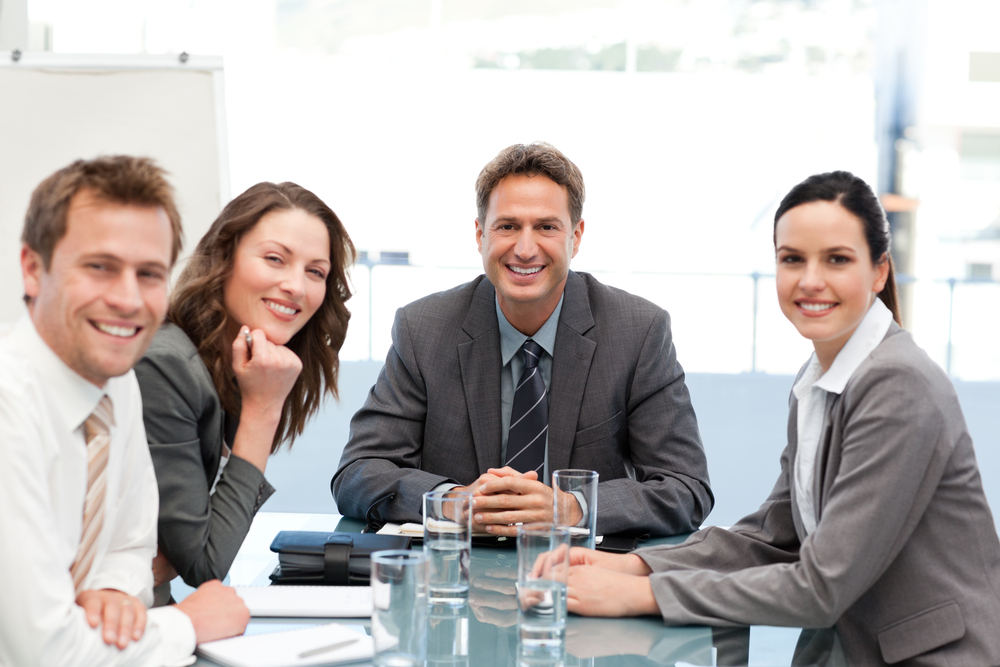 Portrait of a positive team sitting at a table