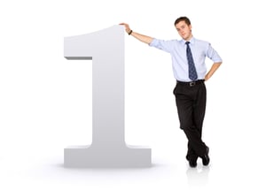 number one with a business man next to it - isolated over a white background